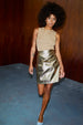 Model wearing Gold Vegan Leather Mini Wrap skirt