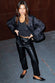 caption_Model wears Black Vegan Leather Trousers in UK 10 / US 6
