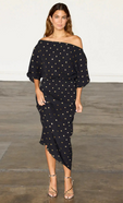 model is wearing the black plisse tilly dress with gold fleck