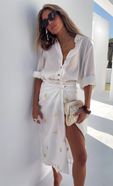 model is wearing a white miley shirt with our white gold snake wrap tie jaspre skirt. Paired with a mirror clutch bag