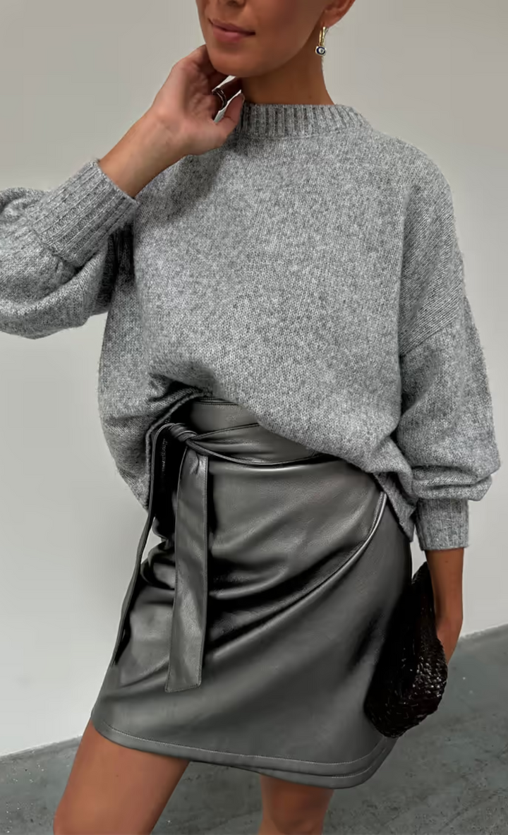 close up of our grey copenhagen knit jumper with the gunmetal vegan leather mini jaspre wrap skirt