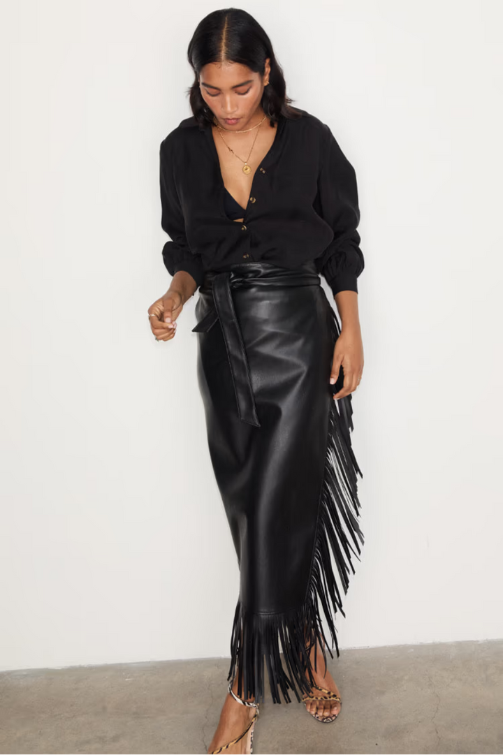 close up of our black vegan leather jaspre wrap skirt with fringe detailing