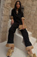 caption_Model wears  Black Raffia Marra Trousers in UK size 8/ US 4