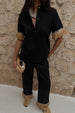 caption_Model wears  Black Raffia Marra Trousers in UK size 8/ US 4