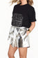 caption_Model wears Silver Vegan Leather Shorts in UK size 10/ US 6
