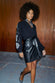 caption_Model wears Black Vegan Leather Mini Jaspre Skirt in UK size 10/ US 6
