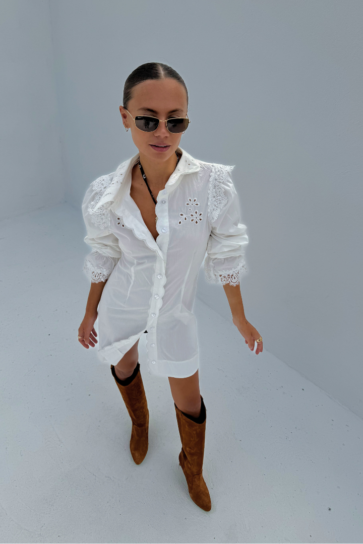 model is wearing our white sicily shirt dress with knee high suede brown boots